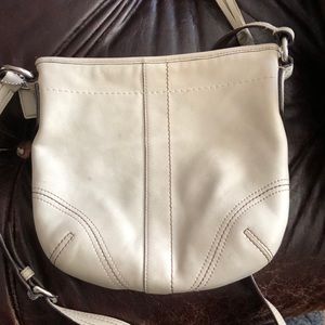 Cross over cream coach bad with inside zipper.